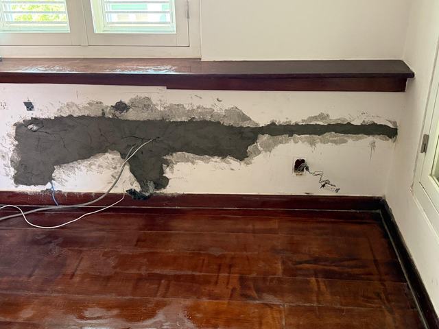 Wall chased under the window for the pipe and cable run