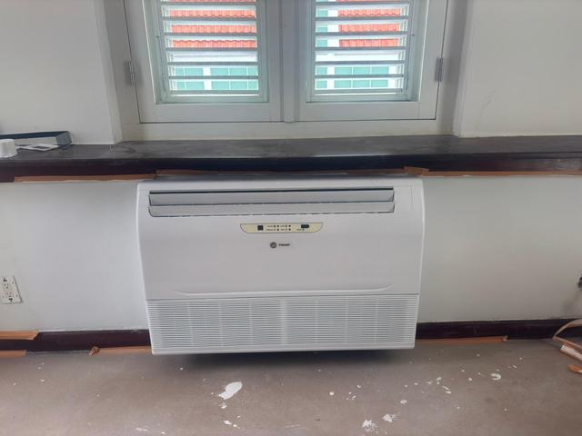 Trane console mounted under the window on the finished wall